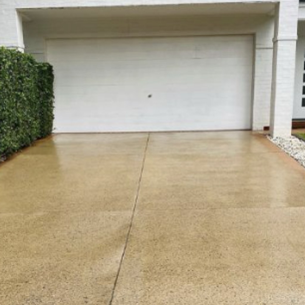 The same concrete driveway cleaned to an even, light finish